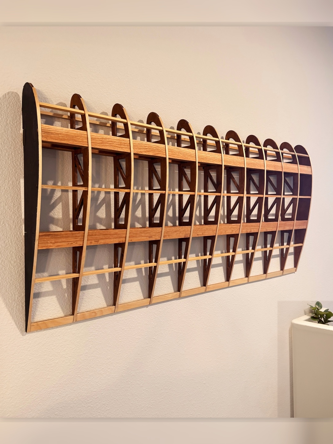 Flightline Furniture
                      Elevator wing rib wall art — left profile mounted on wall showing wing rib geometry detail —
                      red oak — Corvallis Oregon