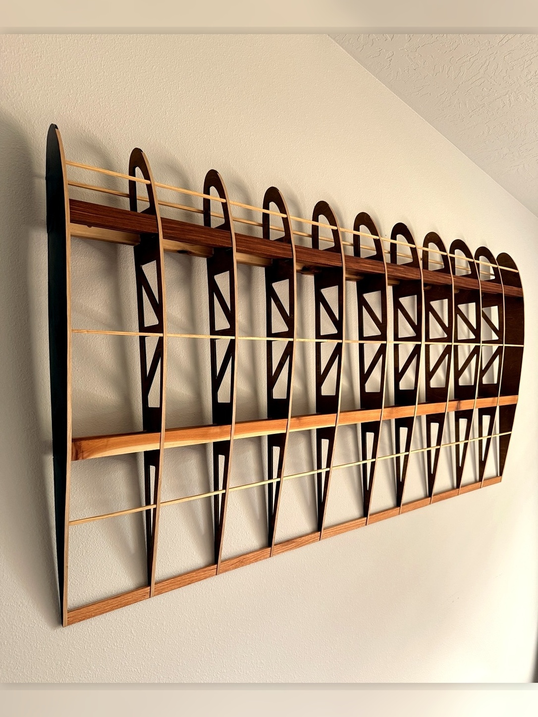 Flightline Furniture Main
                      Wing wing rib wall art — left profile mounted on wall — red oak — Corvallis Oregon